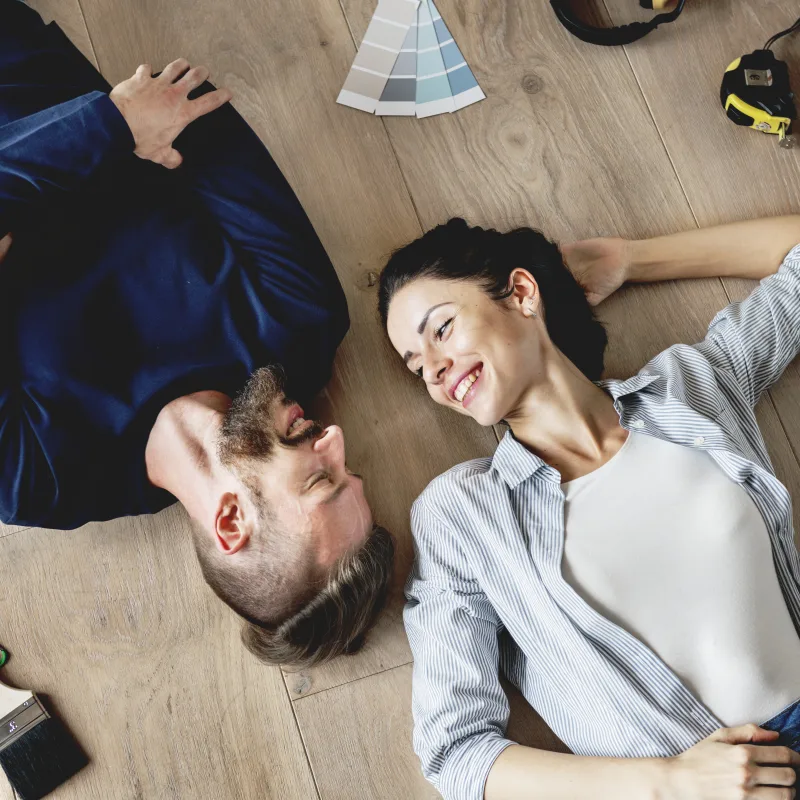 Family lying on a wood floor by Geneva Flooring