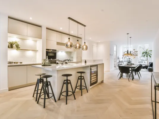 Waterproof herringbone patterned flooring planks in a bright modern kitchen