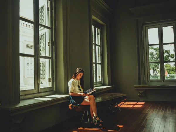 Girl reading in an open heritage home with Engineered Hardwood floors